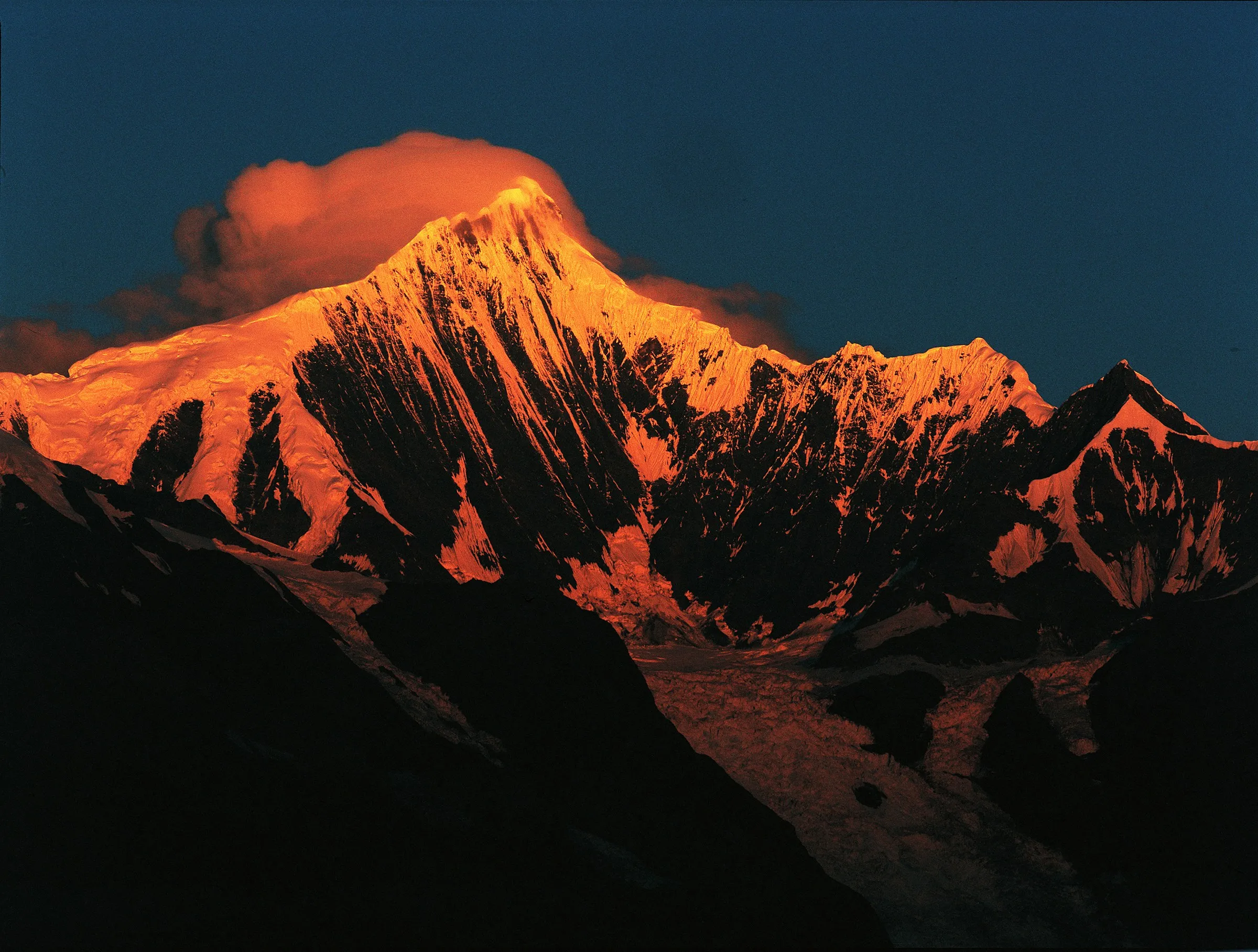 Sunset light on a snow-covered Himalayan summit, Eastward template photography